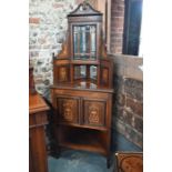 An late 19th century two part inlaid rosewood corner cabinet