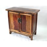 An antique Chinese distressed red lacquered cabinet
