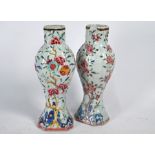 A pair of Chinese Yongzheng/Qianlong period famille rose vases