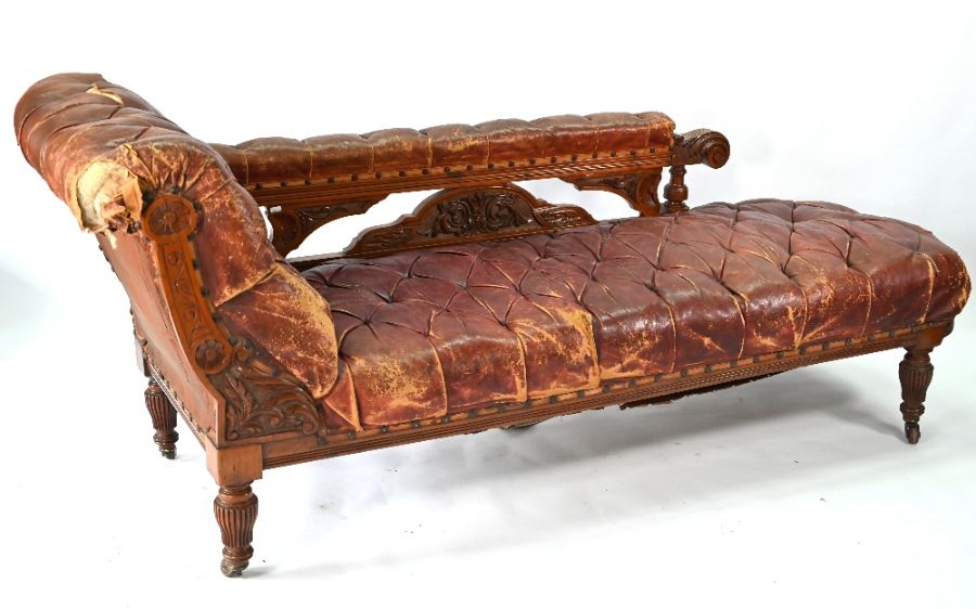 A late 19th century battered buttoned burgundy leather walnut framed chaise - Image 2 of 4