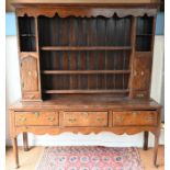 An 18th century mahogany cross-banded oak high dresser