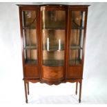 An Edwardian Sheraton revival style inlaid centre bow fronted display cabinet