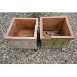 A pair of square terracotta garden planters