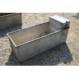 A galvanized riveted steel rectangular trough of planter