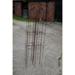 A set of four weathered steel ball head garden obelisks