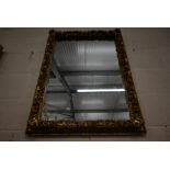 A rectangular wall mirror in floral design giltwood and gesso frame