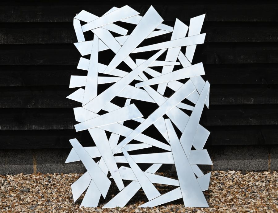 A contemporary multi-faceted wall mirror