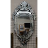 A Venetian style bevelled and etched shield form wall mirror