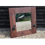 A large overmantle mirror in stained pine frame