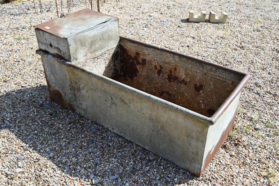 A galvanized riveted steel rectangular trough of planter