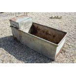 A galvanized riveted steel rectangular trough of planter