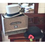 A boxed bowler hat and a boxed top hat