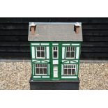 A mid 20th century painted-wood half-timbered dolls house with partial contents