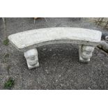 A weathered and reconstituted cast stone garden bench