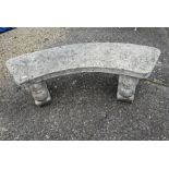 A weathered and reconstituted cast stone garden bench