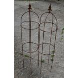 A pair of small weathered steel arrow head obelisks