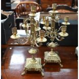 A pair of Renaissance style gilt metal five branch table candelabra