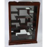 A Chinese hardwood wall hanging display cabinet