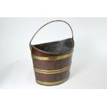 A George III brass bound coopered mahogany bucket