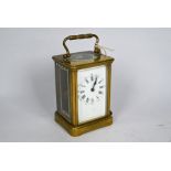 A late 19th century brass carriage clock with signe train 8-day movement