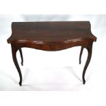 A 19th century mahogany serpentine form card table