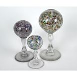 Three floral glass pedestal paperweights