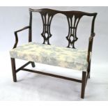 An antique mahogany framed double chair-back sofa