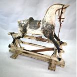 An antique painted wood and gesso large rocking horse