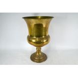 A large brass jardiniere in the form of a goblet