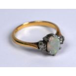 A three-stone opal and diamond ring