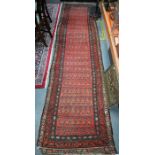 An antique Persian Hamadan carpet runner, 380 cm x 100 cm