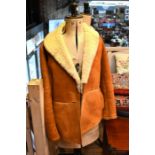 A tan/sand sheepskin jacket with belt