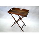 A Victorian mahogany butler's tray on folding stand