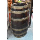 An antique ovoid brass bound coopered oak rum-breaker barrel