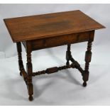 An antique oak table with frieze drawer