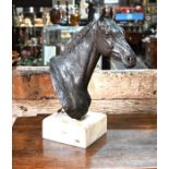 A well-executed brown-patinated bronze horse's head sculpture