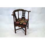 A George III mahogany corner elbow chair