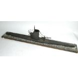 A painted wood waterline model of a World War I German U-boat