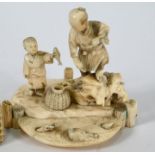 A 19th century Japanese ivory okimono of a fisherman and his son, Meiji, 8 cm high