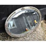 An oval Arts & Crafts hammered pewter mirror