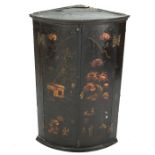 An 18th century Japanned barrel front hanging corner cabinet