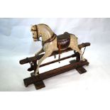 An antique painted wood rocking horse