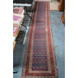 An antique Persian-Kurd runner, 414 cm x 92 cm