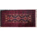 A contemporary red ground Turkish rug, 280 cm x 105 cm