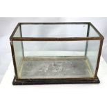 An antique brass-framed aquarium with slate base