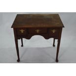 An early 18th century oak three drawer lowboy