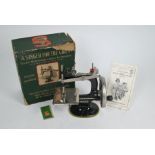 A vintage boxed toy Singer sewing machine