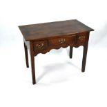 A George III oak table, with three drawers