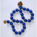 A row of uniform lapis lazuli beads