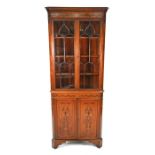 An Edwardian Sheraton Revival inlaid satinwood corner display cabinet